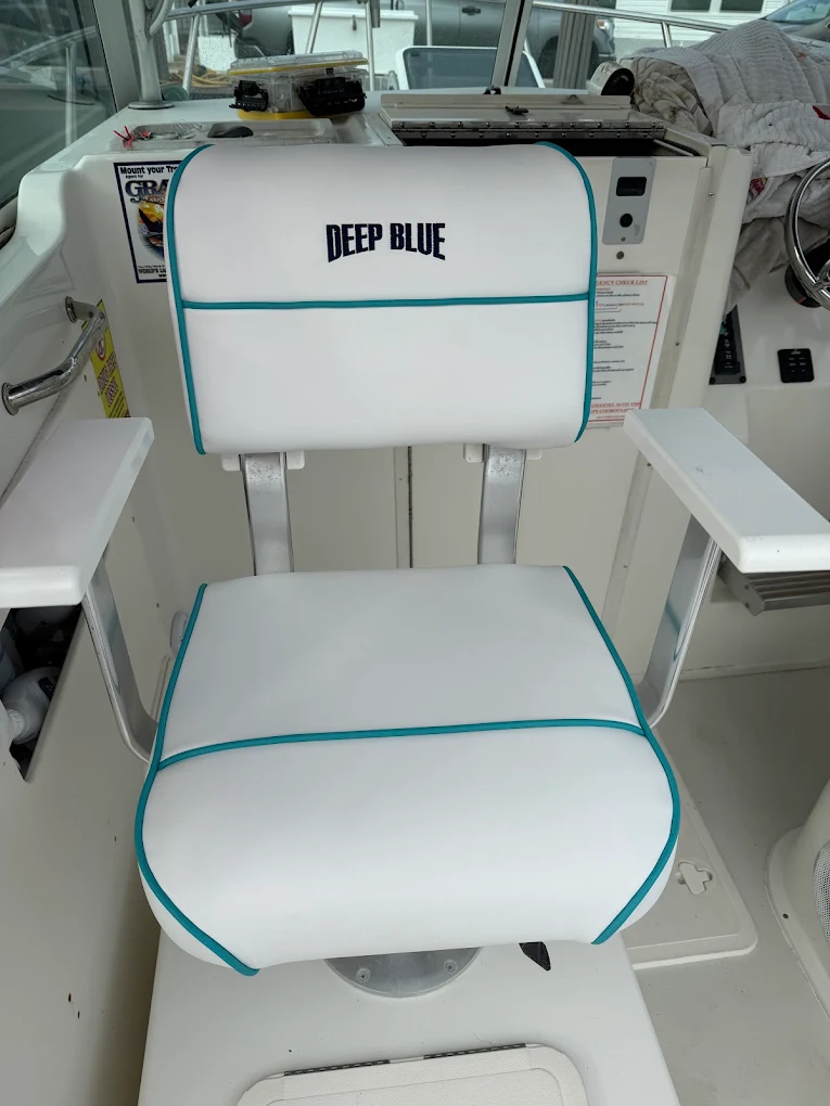 White helm chair with teal piping and custom lettering
