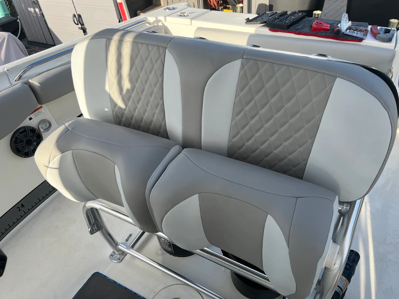 Two-tone gray diamond-stitch bench and flip-up bolsters